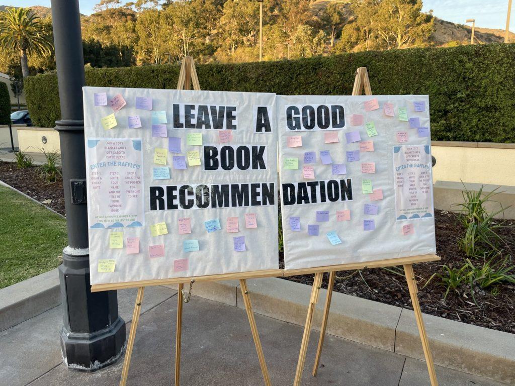 Various sticky notes line a poster containing book recommendations. Students could leave a sticky note for a chance to win a blanket and $15 Caffe Luxxe gift card. Photo by Mackenzie Krause