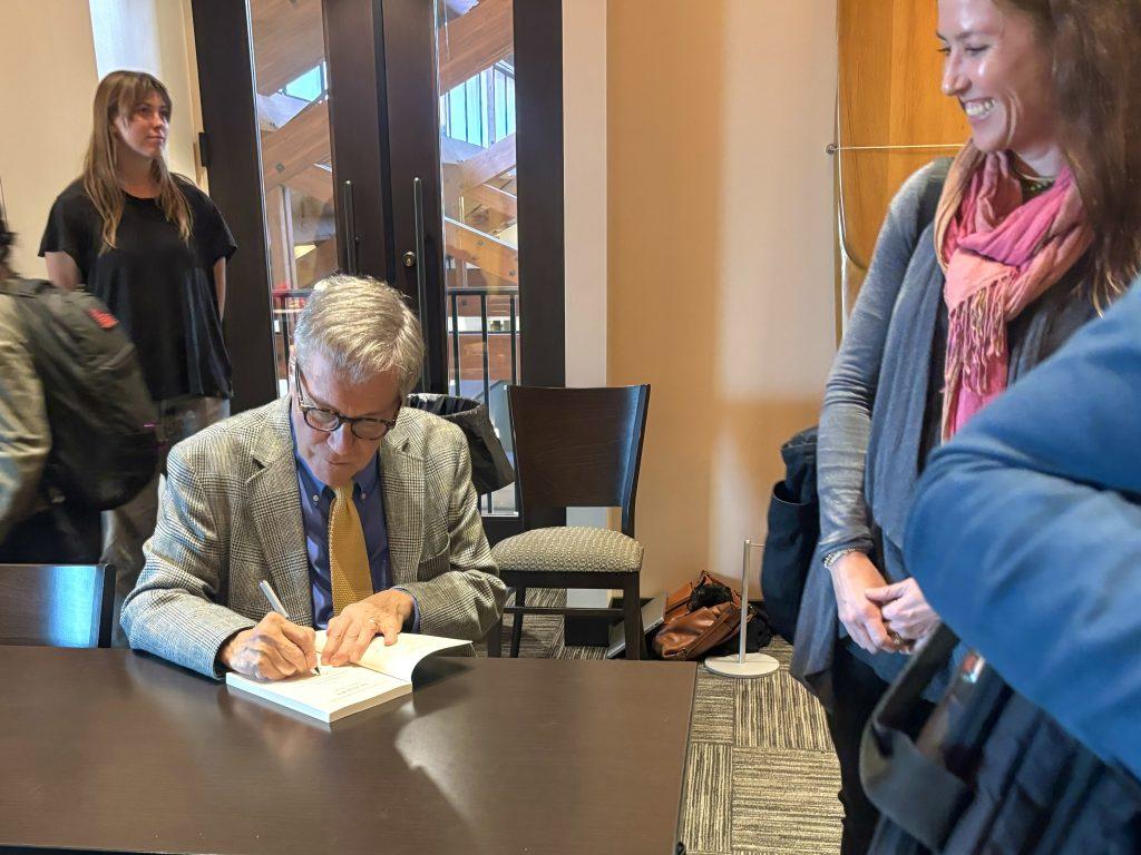 Dana Gioia signs copies of his work in the Surfboard Room at Payson Library on Nov. 14. Gioia met attendees after the poetry event held by Pepperdine Libraries and the Humanities and Teacher Education Division.