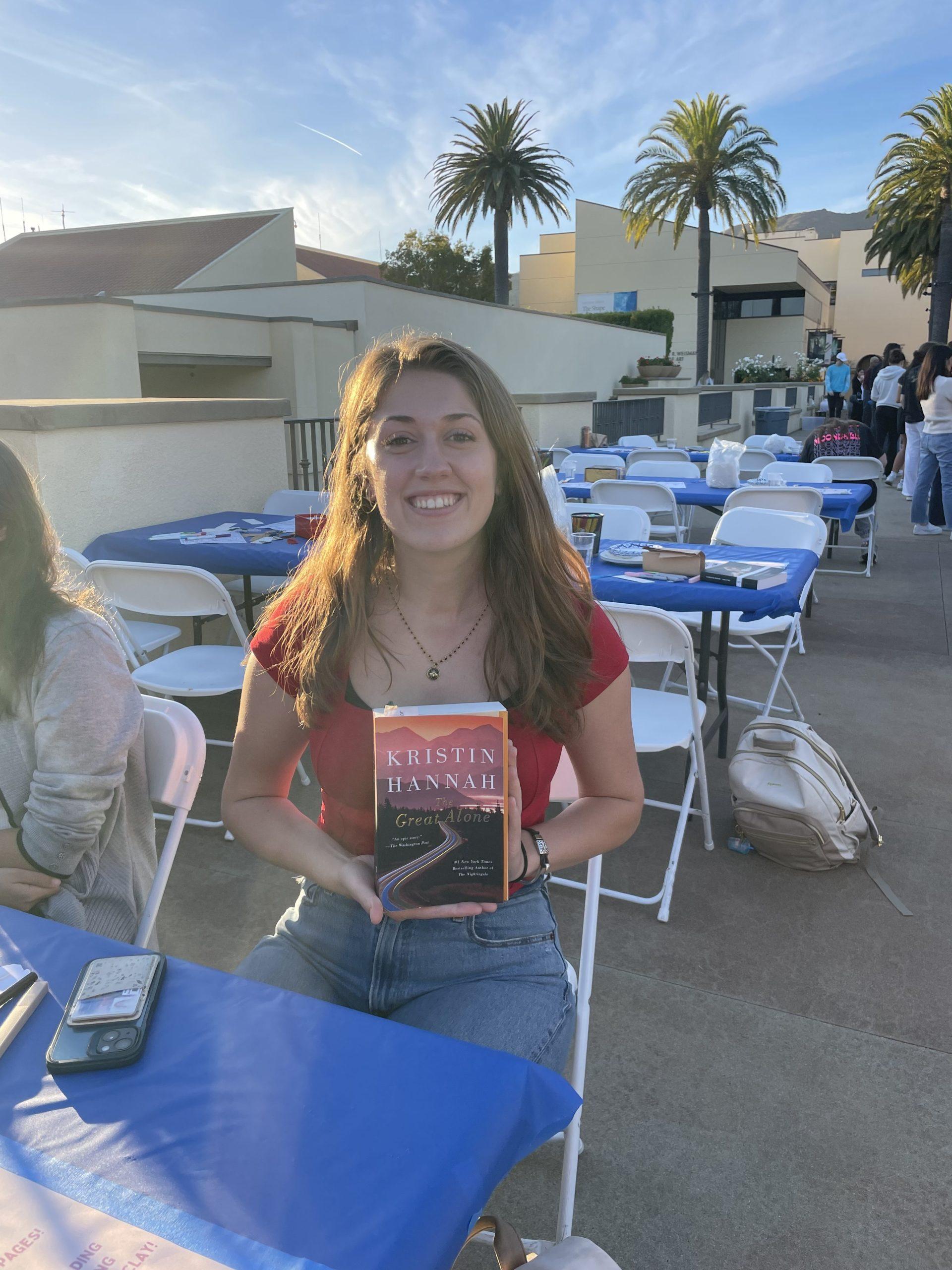 Sharky Smalling is holding the book she received at the Blind Date with a Book Event. The book is called The Great Alone by Kristin Hannah. Photo by Mackenzie Krause