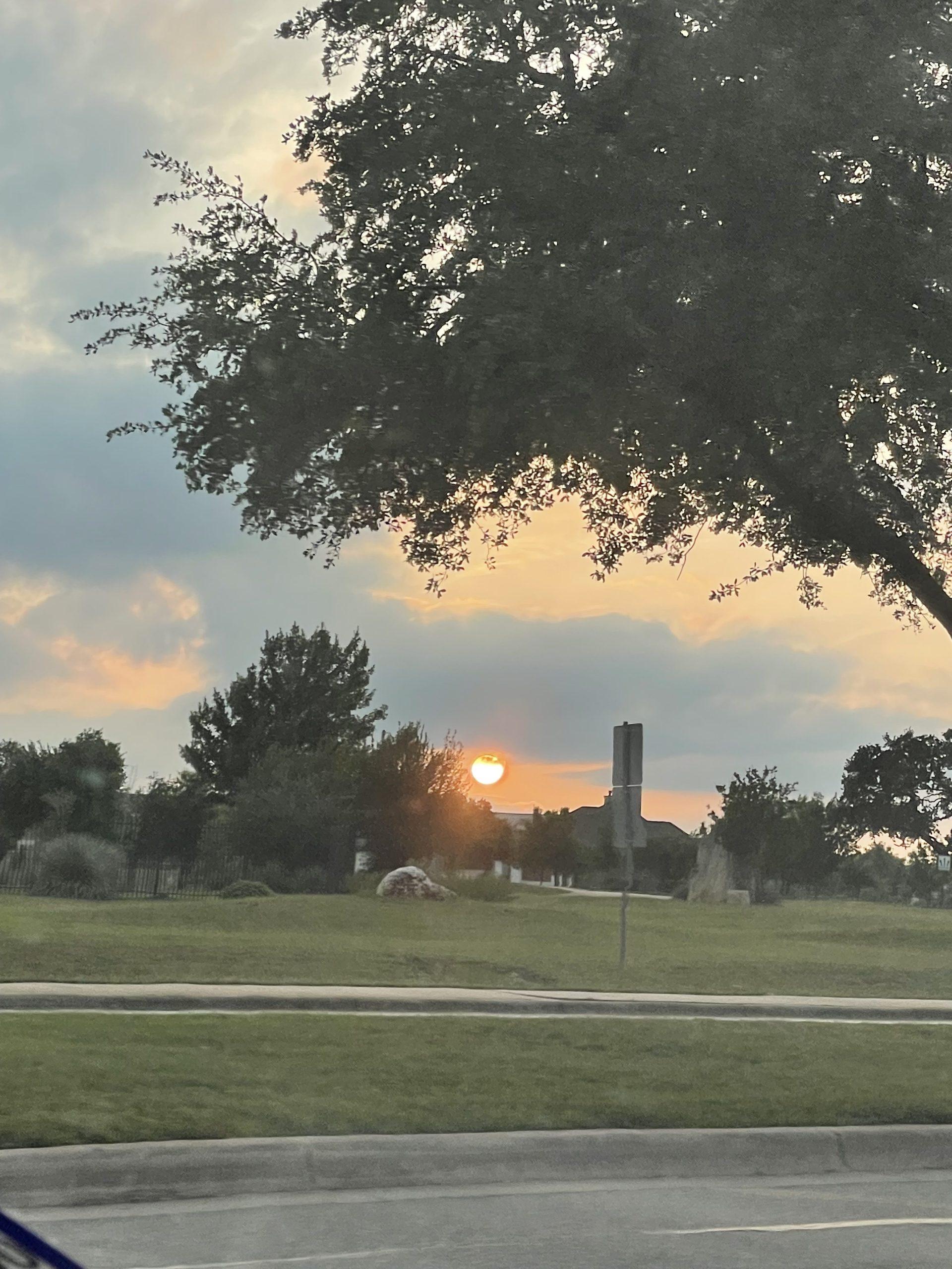 A sunset from my dad's car in Leander, Texas on May 10, 2023. I stopped to take this photo on my way home from work.