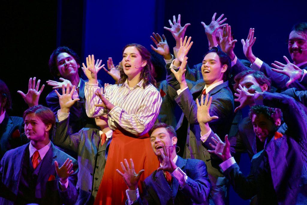 Violet Newstead, played by junior Zoe O’Donnell, is surrounded by the ensemble during a dress rehearsal in Smothers Theatre on Nov. 12. O’Donnell’s role is characterized by her fierceness and intellect, which she weaponizes for good. Photos by Mary Elisabeth