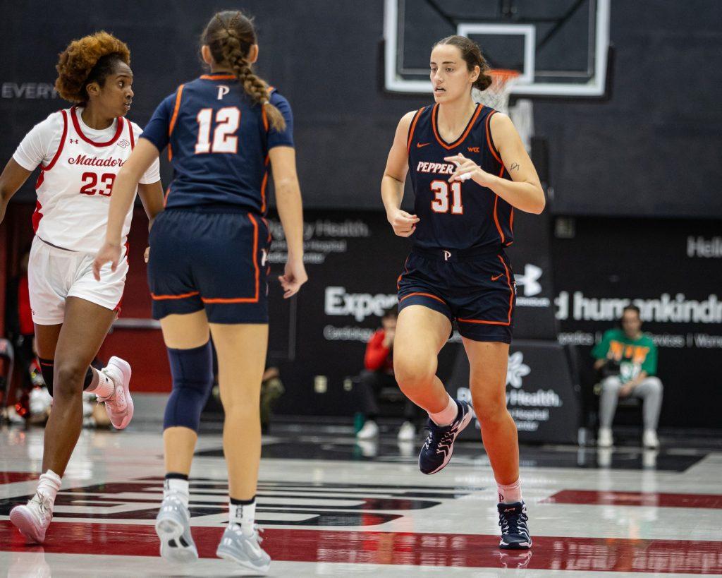 (Left to right) Senior guard Makena Mastora and Harkey run back to defend against CSUN on Nov. 27 at Premier America Credit Union Arena. Makena picked up nine points in the Waves' win with Harkey dazzling offensively and defensively, picking up 16 points, seven rebounds and six blocks.