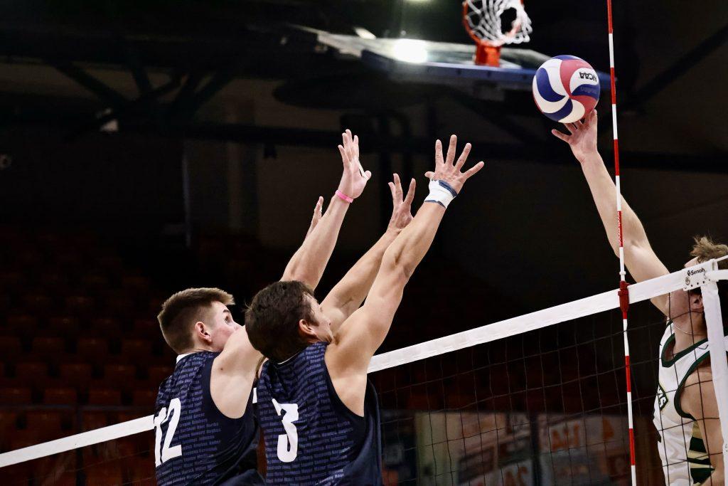 Graduate setter Gabe Dyer and redshirt sophomore middle blocker Ethan Watson jump for a block against Missouri S&T at Firestone Fieldhouse. Watson finished the match with 4 block assists.