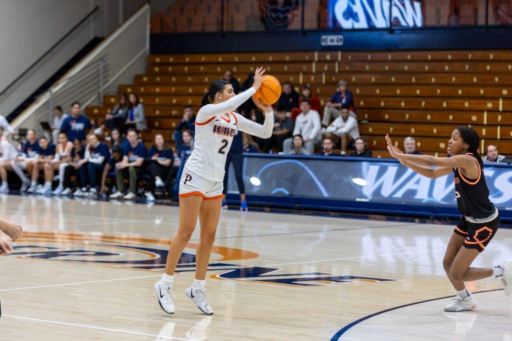 Freshman guard Chloe Sotell attempts a three against University of the Pacific on Jan. 23 at Firestone Fieldhouse. Sotell is the youngest player on the team, joining the Waves to head start the rebuilding process. Photo by Colton Rubsamen