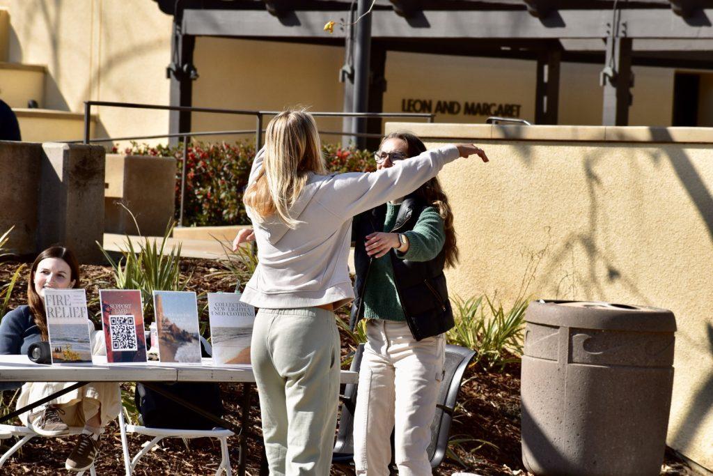 Two Seaver students embrace one another on Mullin Town Square on Tuesday, Jan. 28. The Pepperdine community is handling the devastation from the fires with "such tenderness," senior Helena Mekuanint said.