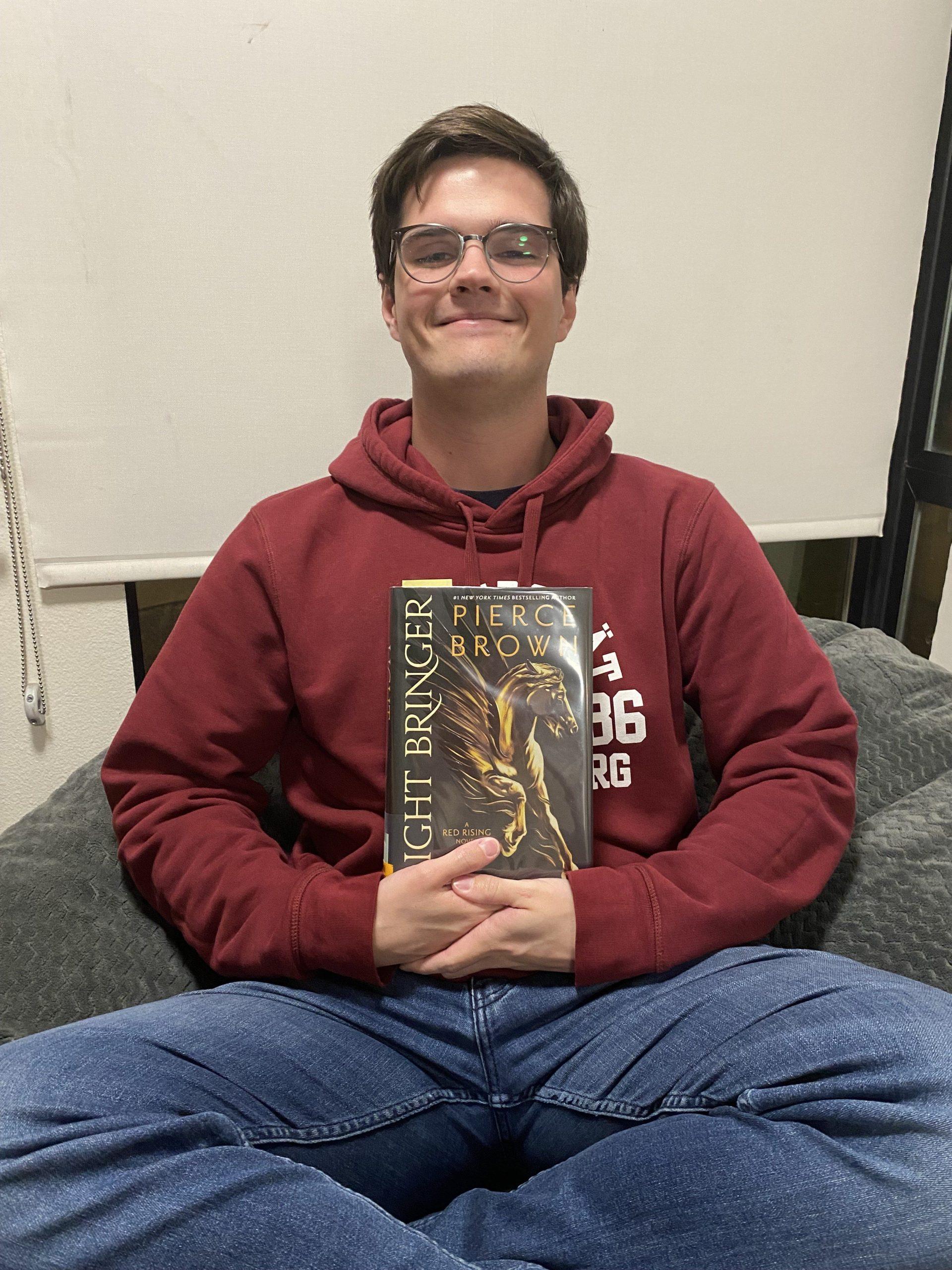 Special Edition Editor Eliot Cox holding a recent favorite of his, Light Bringer by Pierce Brown. I fell in love with the world and characters, and was unable to put it down after finishing the last two books in the series over break. Photo Courtesy of Isaac Albaugh.