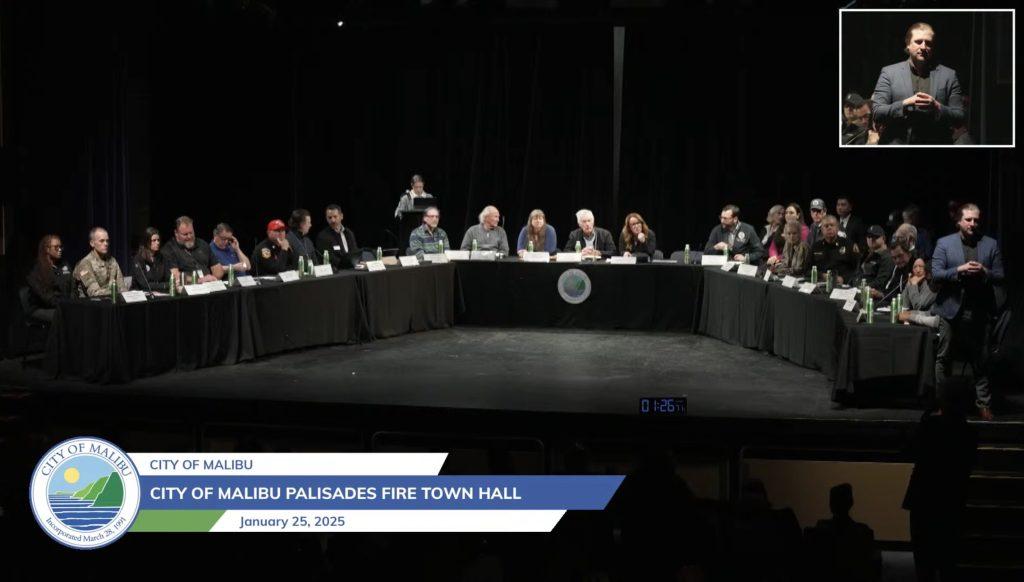 Leaders and representatives from federal, state and local agencies sit on the auditorium stage at Malibu High School. They answered Malibu residents' questions and responded to their concerns about the Palisades Fire. Photo courtesy of the City of Malibu