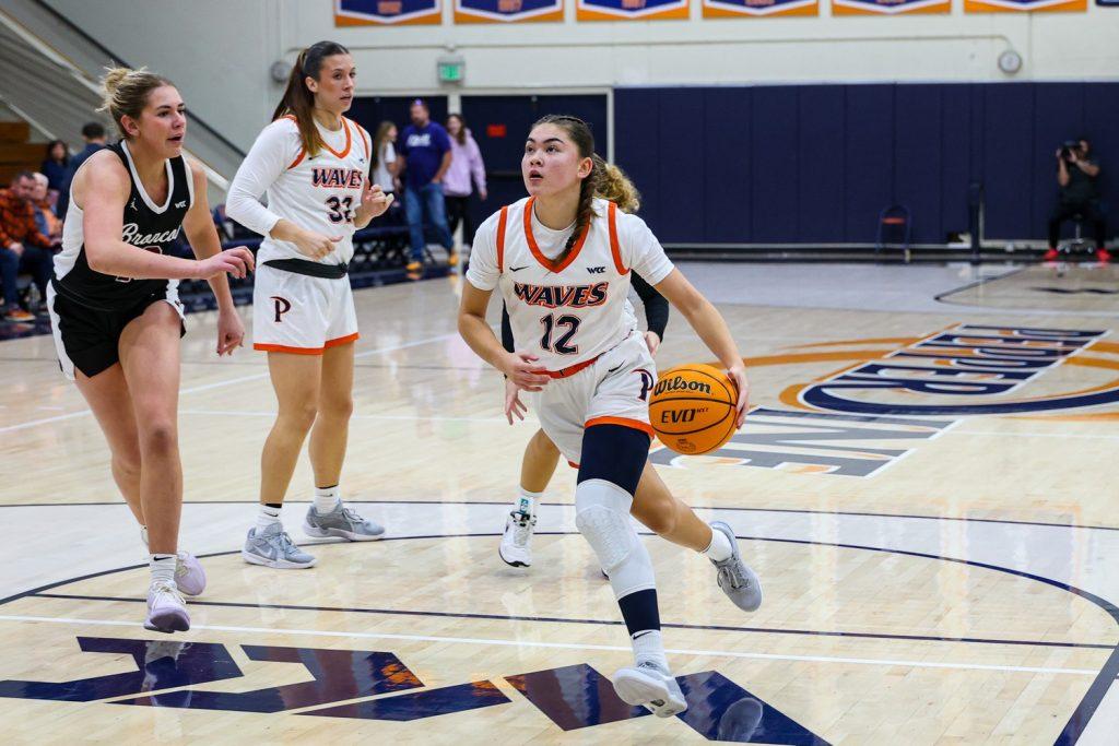 Senior guard Makena Mastora attacks the rim at Firestone Fieldhouse against Santa Clara University on Dec. 21. Makena is one of the many competitive student-athletes that make up the Women's Basketball team, expressing her determination to finish her last season strong. Photo courtesy of Makena Mastora