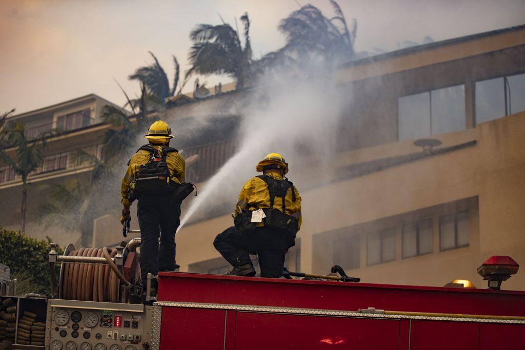 Firefighters work to save a building from the Palisades Fire. The fire destroyed homes and businesses in the Pacific Palisades and Malibu. Photo courtesy of Ryan Bough