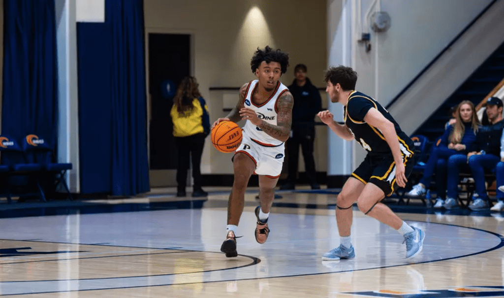 Freshman guard Taj Au-Duke challenges up against Life Pacific in a fast break Dec. 4 in Firestone Fieldhouse. Pepperdine defeated Life Pacific by 62 points.