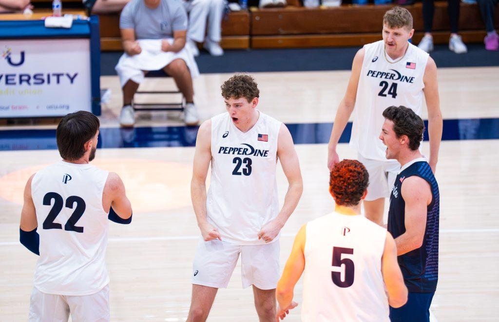 Freshman middle blocker William Whidden celebrates with the team as he scored the winning point of set one. Whidden was one of the key players on defense, blocking the Lions' attacks that led to numerous successful plays.