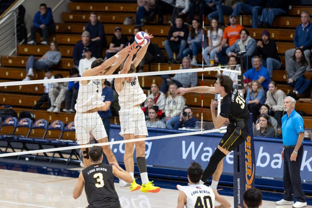 Sophomore middle hitter Ethan Watson and Hartke jump for the block against Long Beach State on Jan. 26 at Firestone Fieldhouse. Watson and Hartke combined for four blocks against Long Beach State.