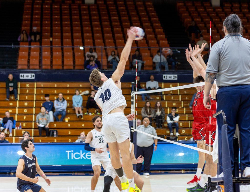 Freshman outside hitter Cole Hartke goes for the hit in Firestone Fieldhouse on Feb. 8. Hartke had another double-digit game executing 16 kills on a .444 cut.