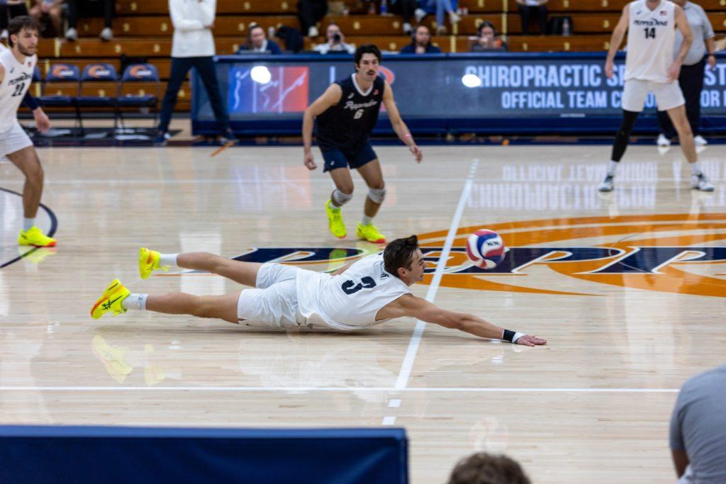 Dyer goes for a pancake in Firestone Fieldhouse on Feb. 8. Dyer was an asset at the net and on defense, raking up a total of six digs throughout the game.