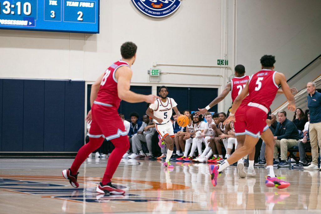 Junior guard Moe Odum dribbles the ball up the court against Loyola Marymount University on Feb. 11 at Firestone Fieldhouse. Odum has scored 299 points through 25 games this season.