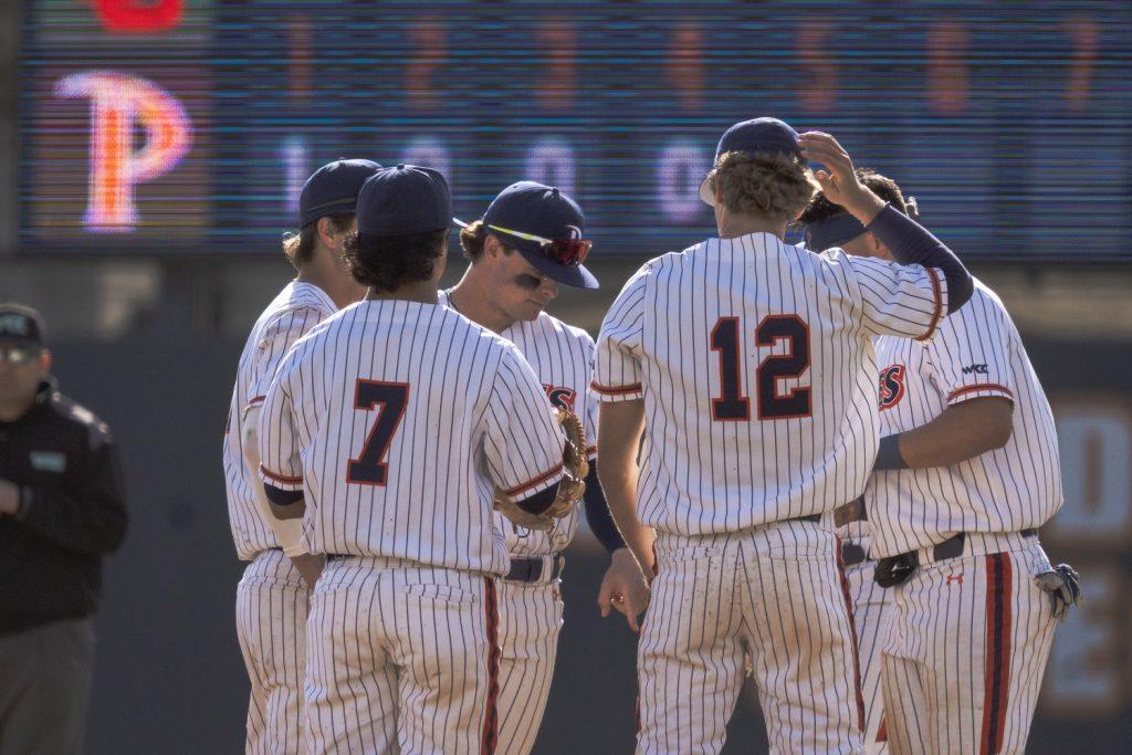 Waves middle infielders senior Julian Nunez (#7) and senior Justin Rubin (#12) huddle with their team during a matchup against Utah on Feb. 14, at Eddy D. Field Stadium. LaTorre said Pepperdine is notorious for having a strong middle infield presence, noting Nunez and Rubin as key players in the season moving forward.