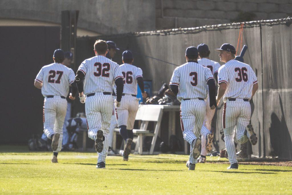 The Waves jog down the right field line during a half-inning against Utah on Feb. 14, at Eddy D. Field Stadium. This is one of many ways the Waves stay prepared and warm during a game.