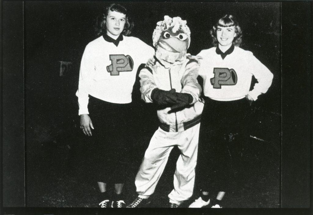 The first costumed edition of Willie the Wave poses with two cheerleaders in 1953. This version of Willie drew inspiration from Pepperdine's previous live mascot, Joe the Pelican, and debuted in 1952. Photo courtesy of Pepperdine Libraries