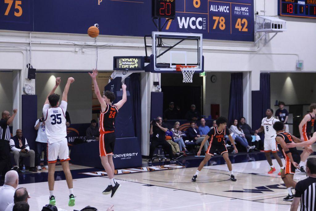 Freshman forward Danilo Donzic goes to shoot a three-pointer against Oregon State in Firestone Fieldhouse on Feb. 20. Donzic played a total of 32 minutes throughout the game.