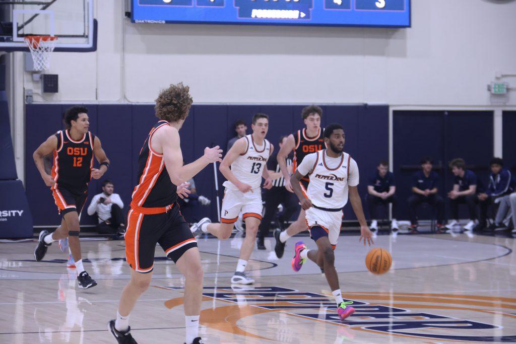 Junior guard Moe Odum dribbles down the court against Oregon State University in Firestone Fieldhouse on Feb. 20. Odum led in assists with a total of seven. Photos by Griffin Pilcher