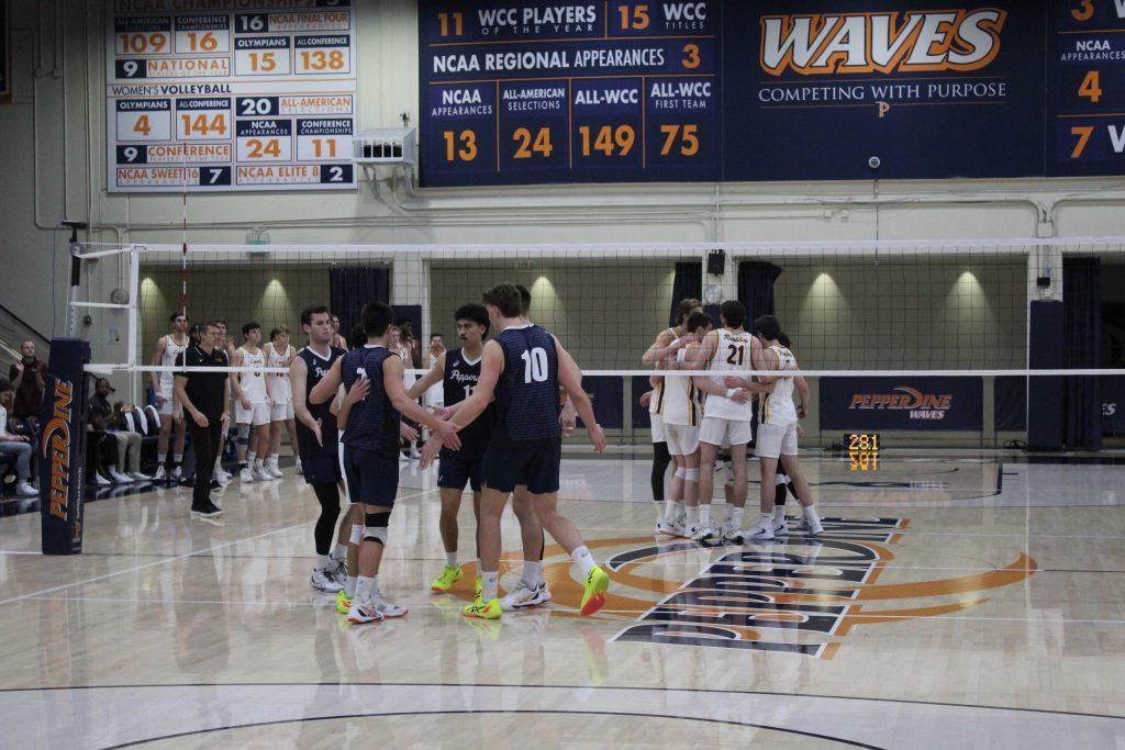 The Waves come together to reconnect before the next point at Fireside Fieldhouse on Jan. 30. Junior libero Jacob Reilly was a crucial part of the team's overall energy throughout the game.