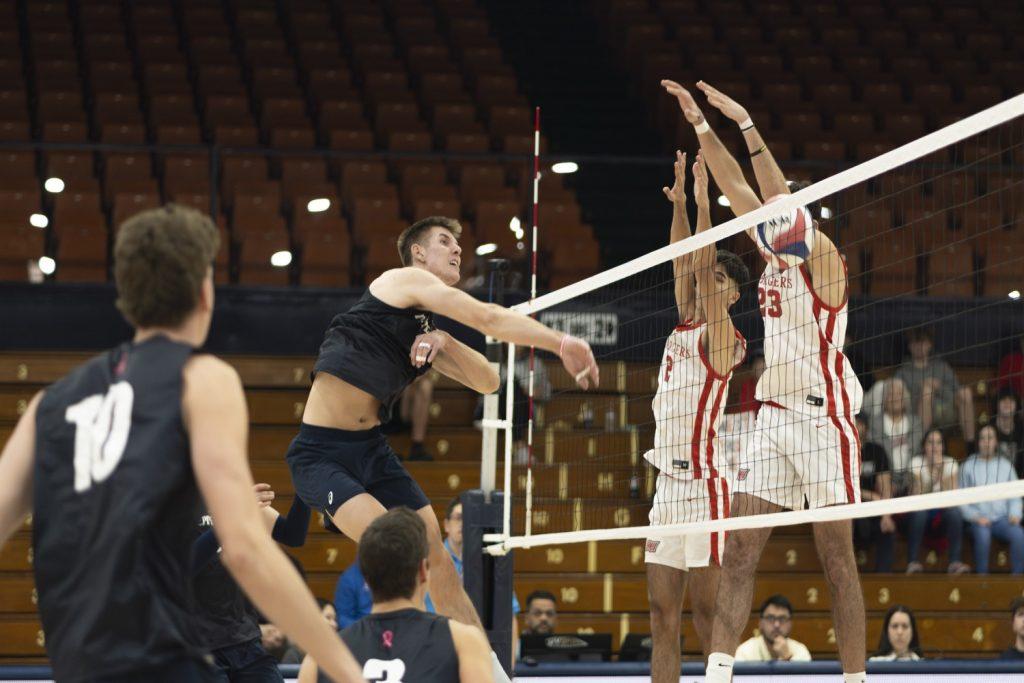 Sophomore middle blocker Ethan Watson spiking for the point against Dominican University New York on Feb. 9 at Firestone Fieldhouse. Watson now has a career total of 131 kills.