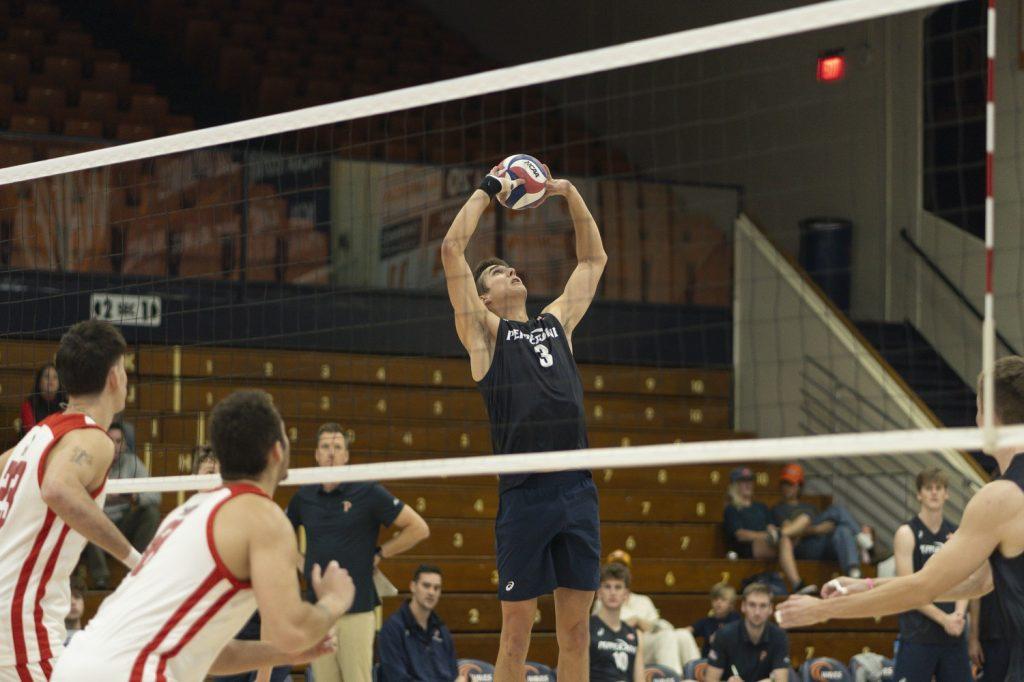 Graduate setter Gabe Dyer setting the ball against Dominican University New York on Feb. 9 at Firestone Fieldhouse. Dyer led in assists with a total of 31 in the game.