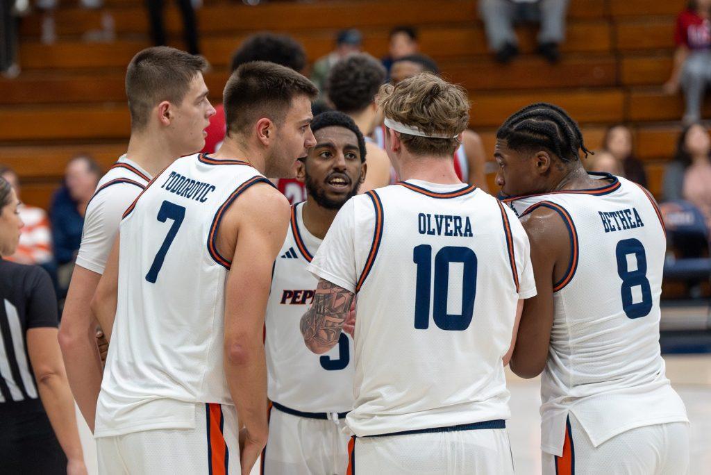 Pepperdine Men's Basketball in a huddle against Loyola Marymount University on Feb. 11 at Firestone Fieldhouse. Pepperdine entered the game with a 3-8 conference record. Photos courtesy of Pepperdine Athletics