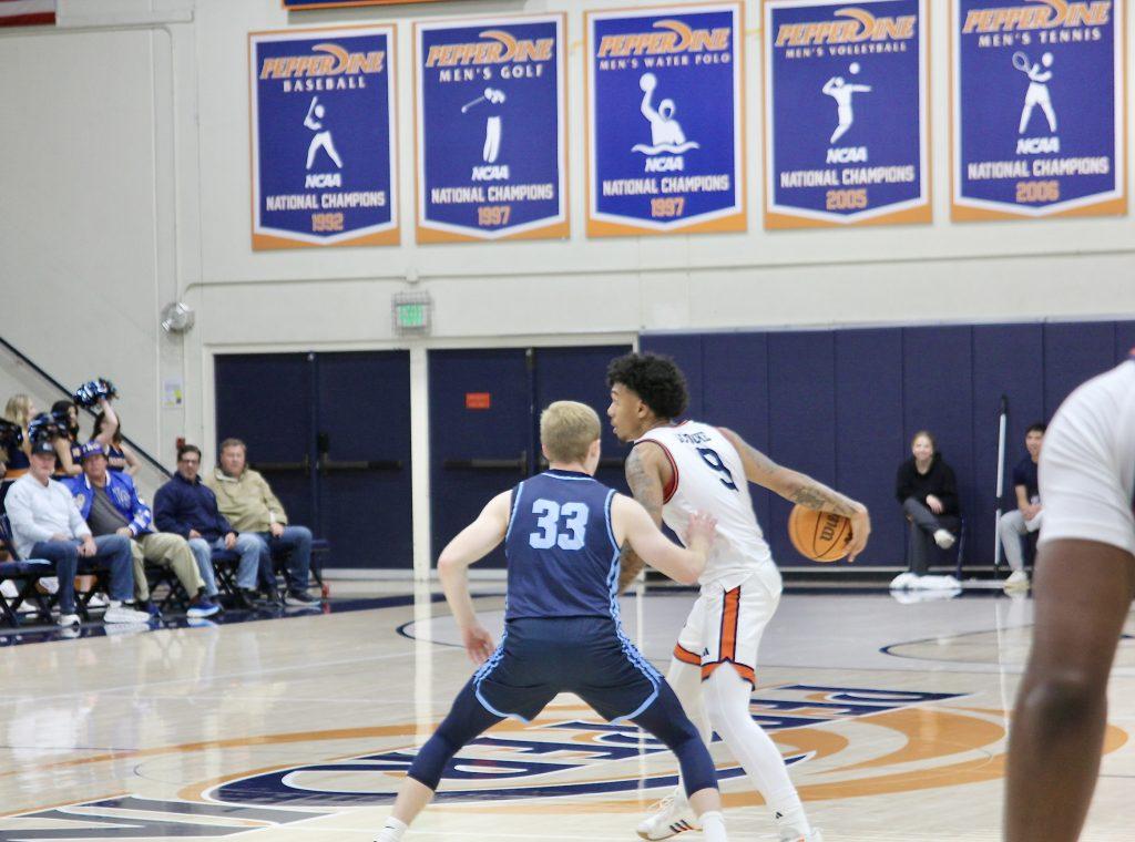 Freshman guard Taj Au-Duke driving the ball down court against University of San Diego on Feb. 13 at Firestone Fieldhouse. Au-Duke has 20 assists on the season.