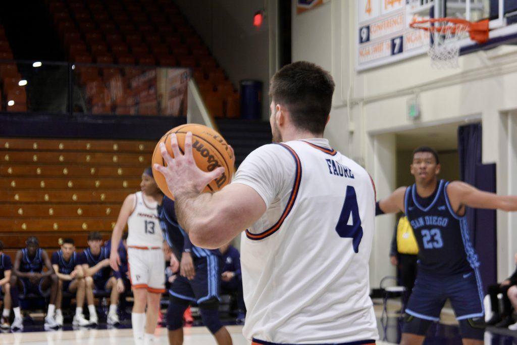 Graduate forward Alonso Faure looks to inbound the ball back into play against University of San Diego on Feb. 13 at Firestone Fieldhouse. Faure has 49 points on the season.