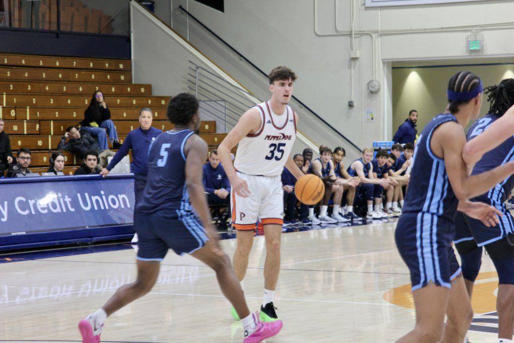 Freshman forward Danilo Dozic dribbling the ball down court against University of San Diego on Feb. 13 at Firestone Fieldhouse. Dozic has 23 points against San Diego this season. Photos by Guinevere Hesse