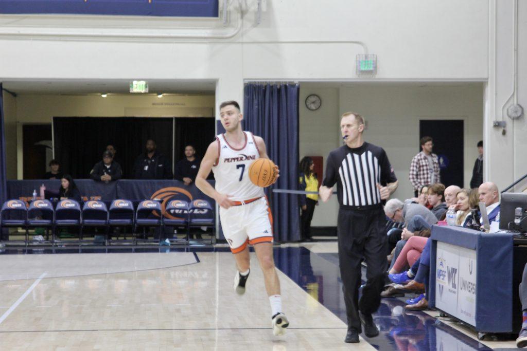 Senior forward Stefan Todorovic dribbling the ball down court after grabbing the rebound against University of San Diego on Feb. 13 at Firestone Fieldhouse. Todorovic has 13 rebounds against San Diego on the season.