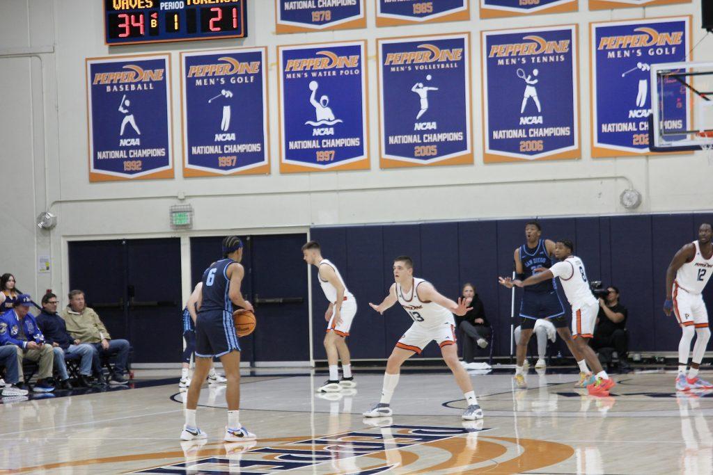 Sophomore guard/forward Dovydas Butka leading the Waves defense against University of San Diego on Feb. 13 at Firestone Fieldhouse. Butka has 12 rebounds against San Diego on the season.