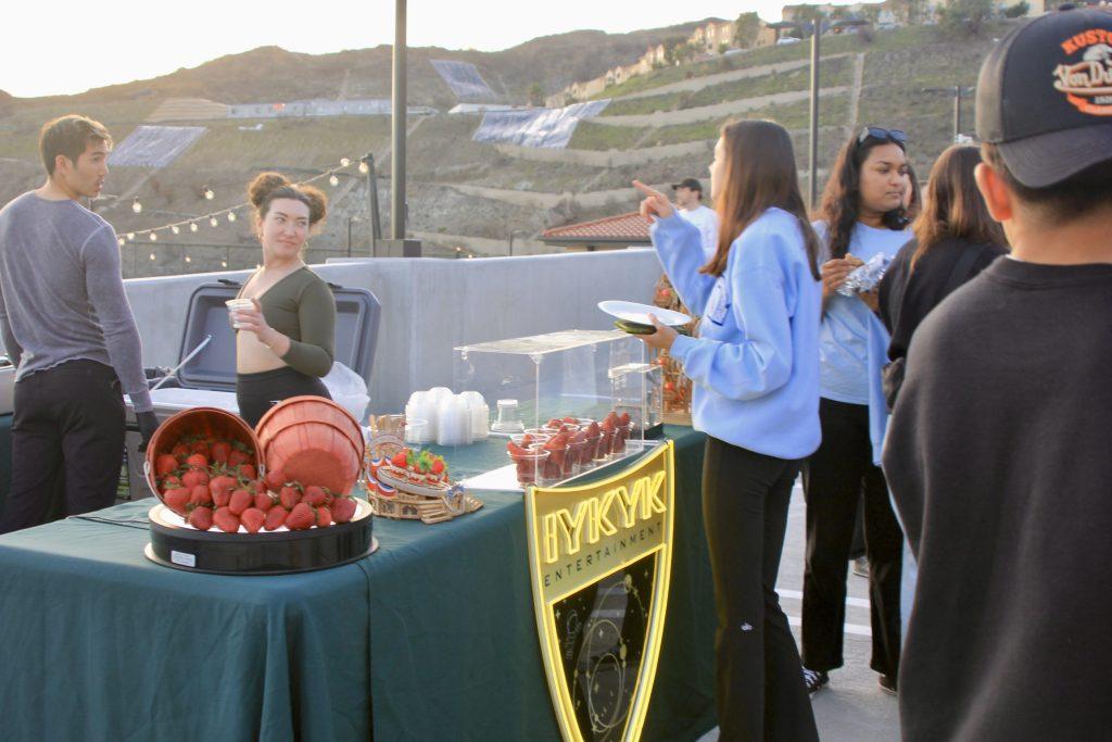 Students wait in line for chocolate-covered strawberries Friday, Feb. 21. There were many different vendors and activities for students to enjoy at the event.