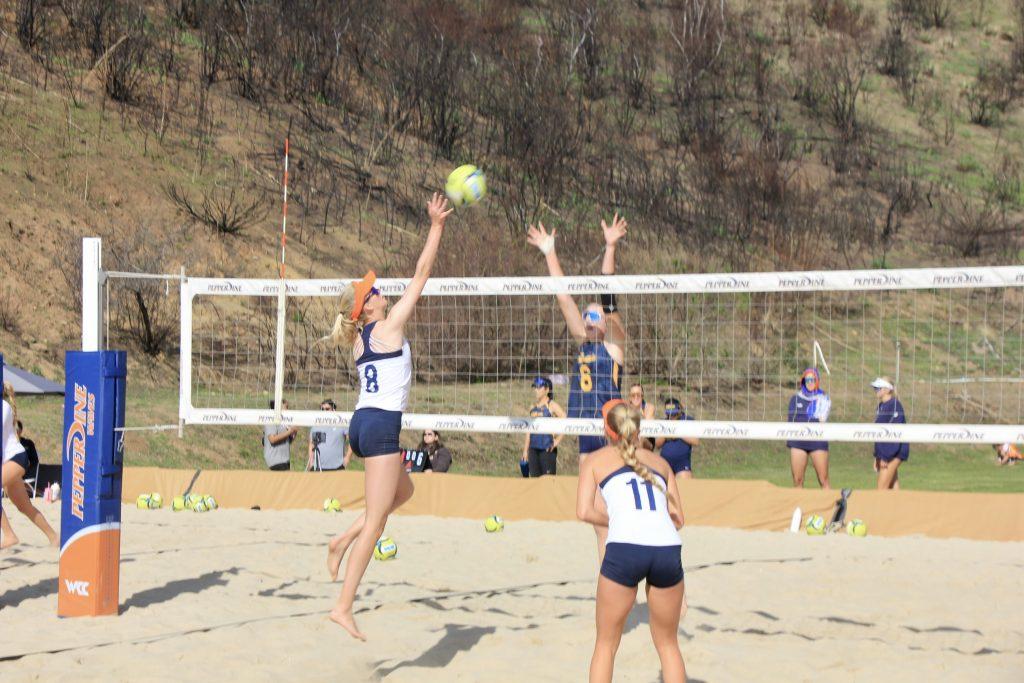 Senior Kate Clermont spikes the ball against Bakersfield on Feb. 21 at the Pepperdine Beach Courts. Clermont and senior McKenna Thomas defeated Bakersfield two sets to zero.