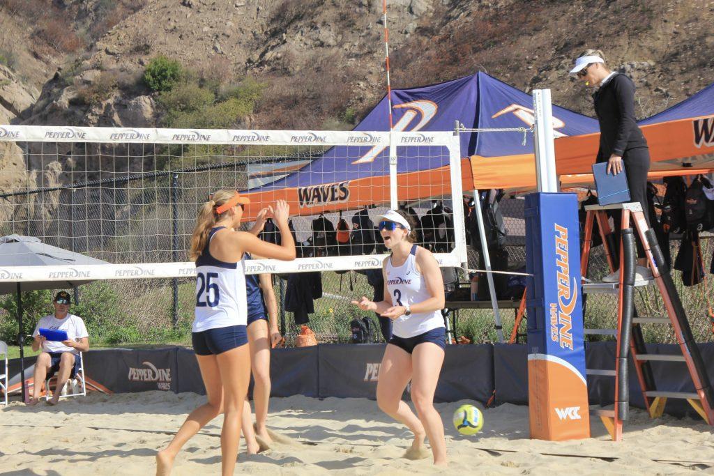 Perez celebrates with graduate Marley Johnson against Bakersfield on Feb. 21 at the Pepperdine Beach Courts. Perez and Johnson finished the day with two sets won and three sets lost.