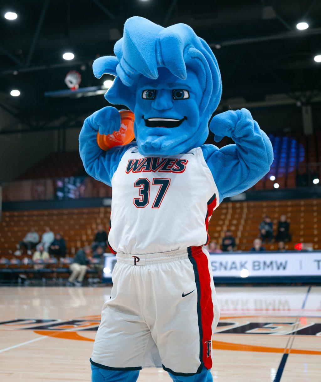 Willie the Wave flexes his muscles at a Pepperdine Men's Basketball's matchup against Loyola Marymount University on Feb. 11, at Firestone Fieldhouse. The current Willie is present at home games at Firestone Fieldhouse. Photo courtesy of Pepperdine Athletics