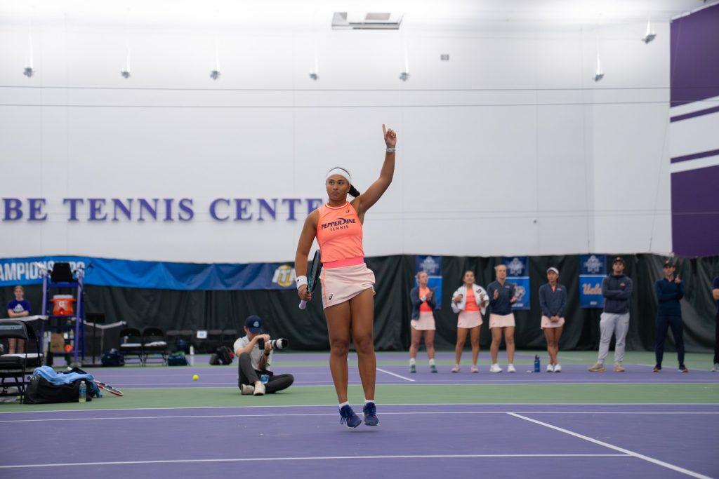 Senior Savannah Broadus points a finger to the air as she faces off against the No. 21 ranked player, gathering a point at Combe Tennis Center on Feb. 7. Broadus remains one of Pepperdine's top competitive athletes with her own national ranking of No.16. Photos courtesy of Pepperdine Athletics.