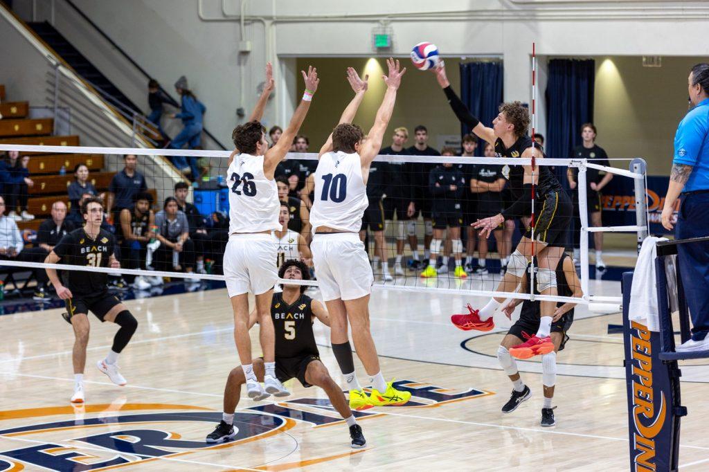 Freshman outside hitter Cole Hartke and sophomore middle blocker James Eadie jump for a block against Long Beach State on January 26 at Firestone Fieldhouse. Hartke and Eadie combined for 4 blocks in the game.