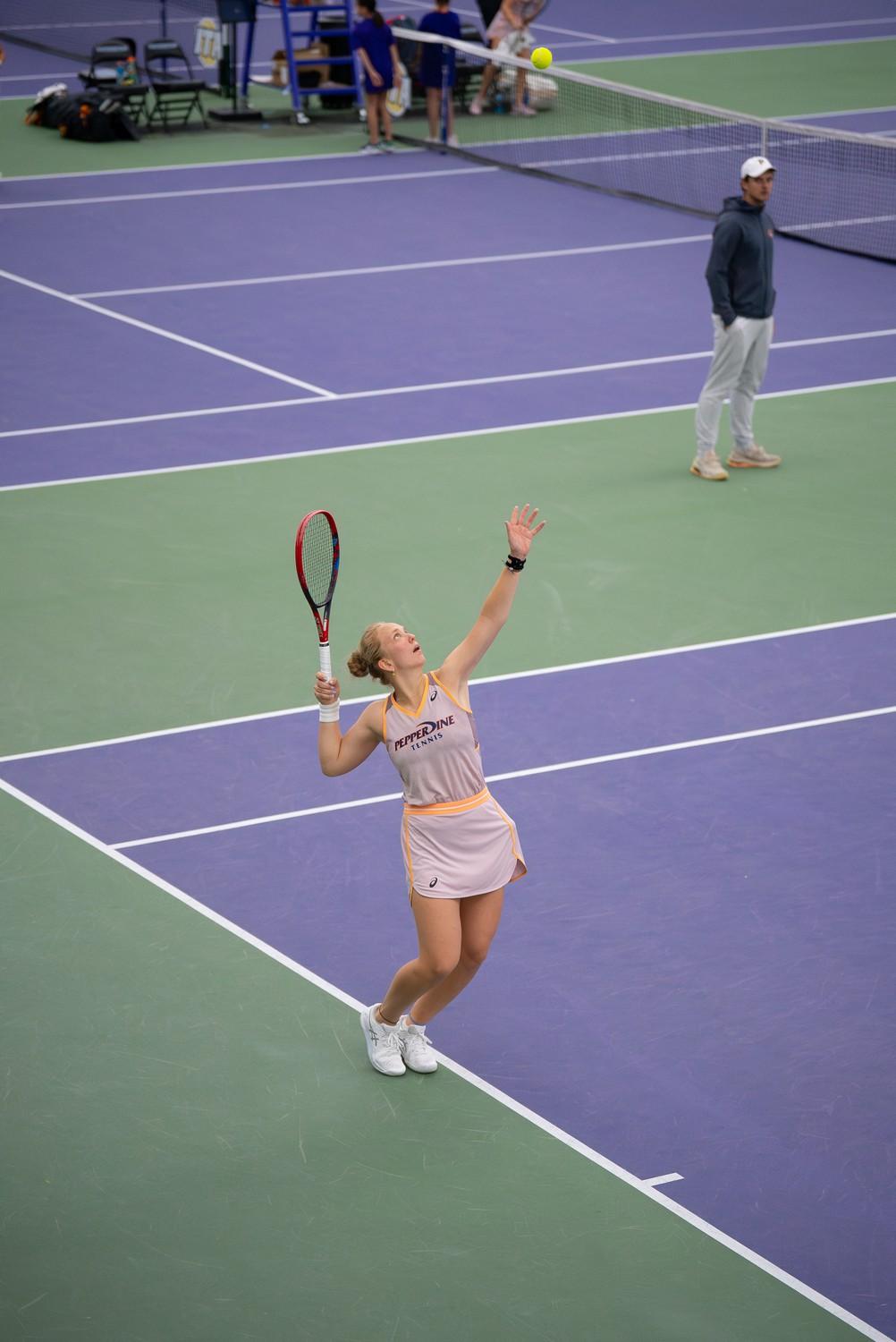 Grechkina positions herself to serve against her University of Tennessee opponent at Combe Tennis Center, playing in the doubles round with her teammate Harmon on Feb. 8. Despite their hard effort, they remain defeated with a score of 6-4.