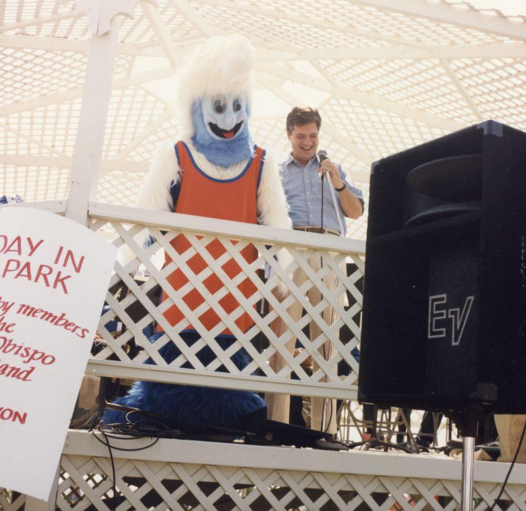 Former President David Davenport presents Willie the Wave at Pepperdine&squot;s 50th year anniversary. This version of Willie the Wave received nicknames like "fur ball." Photo courtesy of Pepperdine Libraries