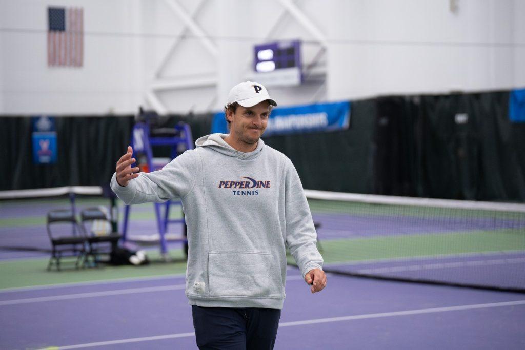 Interim Head Coach Tassilo Schmid congratulates the victorious Pepperdine athletes, sharing a heartfelt smile as they won against Northwestern University at Combe Tennis Center on Feb. 9. With a score of 4-1, the Waves concluded their run at the 2025 ITA National Team Indoor Championships.