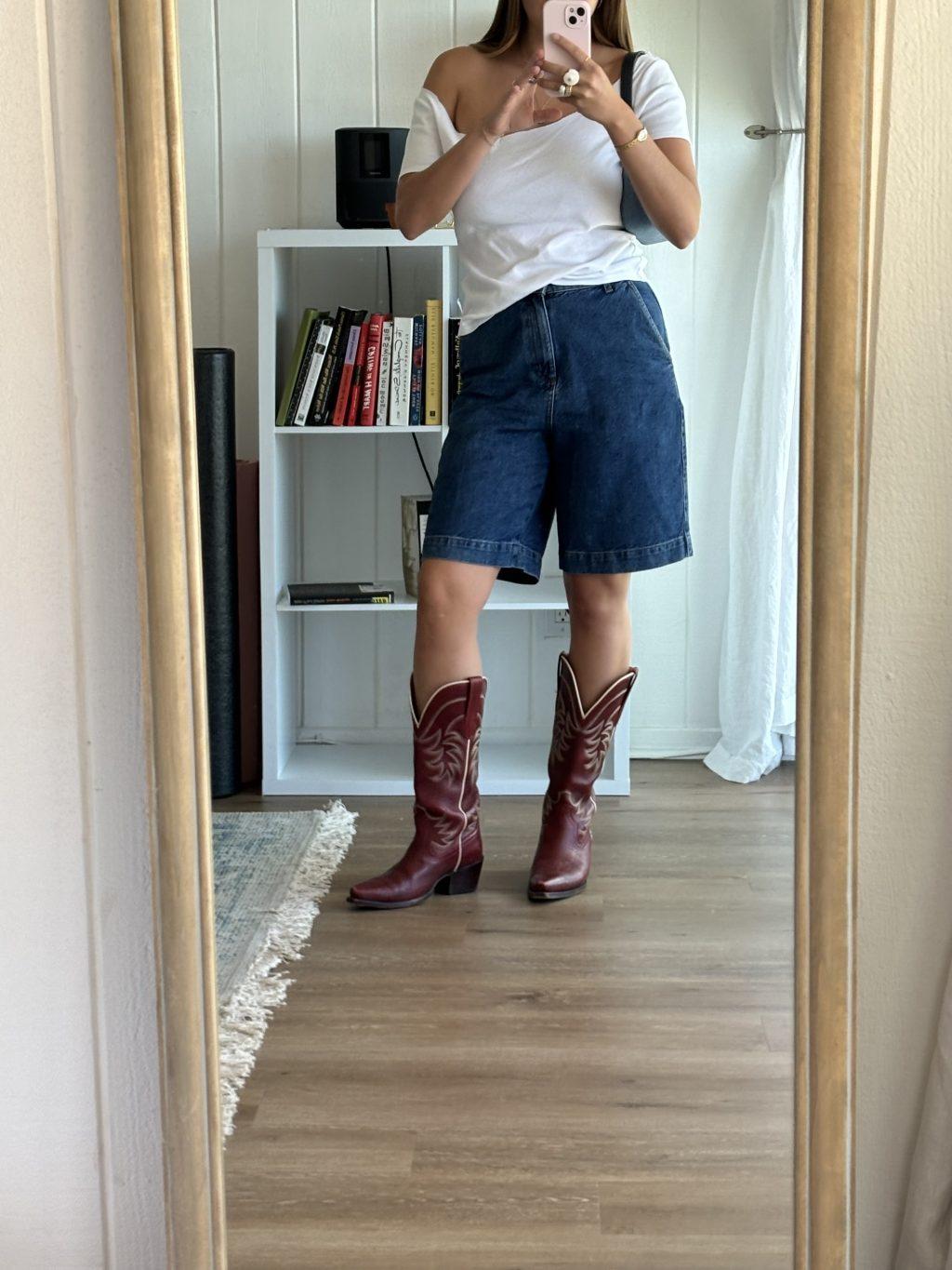 Junior Mary Papillion combines her pair of jorts with a white top and cowboy boots June 2024. She said light neutrals paired with dark denim are her go-tos. Photo courtesy of Mary Papillion