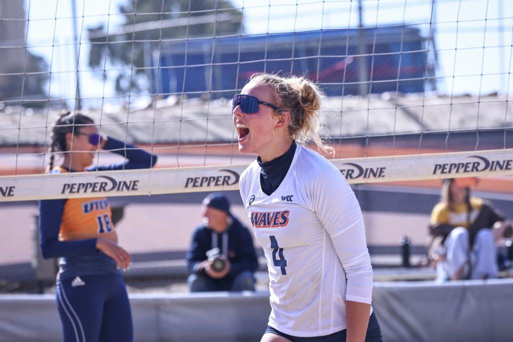 Freshman Emma Eden celebrates after a point against the University of Texas at El Paso on March 15 at the Pepperdine Beach Volleyball Courts. Eden and her teammates brought energy to every game to have an undefeated weekend. Photo courtesy of Kennedy Duke