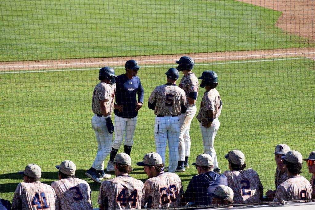 Members of Pepperdine Baseball huddle around Assistant Coach Dane Stankiewicz during a pitching change against the University of Nebraska Huskers on March 19, at Eddy D. Field Stadium. The Waves ended non-conference play with a 4-15 record. Photo by Mary Elisabeth