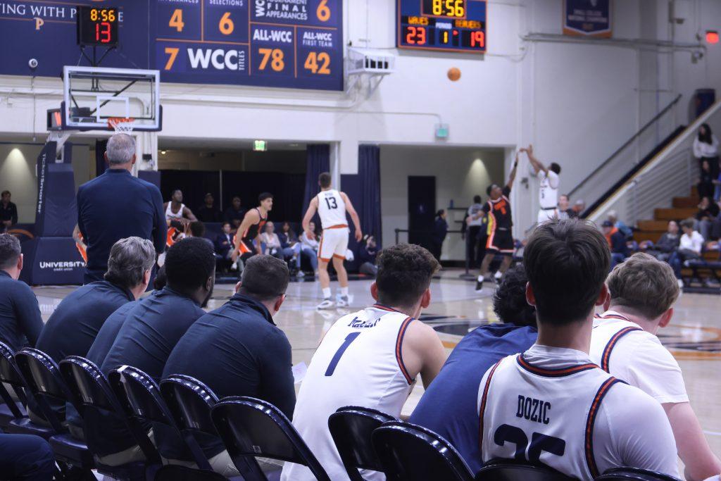 Head Coach Ed Schilling (standing left) watches the team against Oregon State University on Feb. 20, at Firestone Fieldhouse. In Schilling's first season as head coach, the team finished with a 10-21 record. Photo by Griffin Pilcher