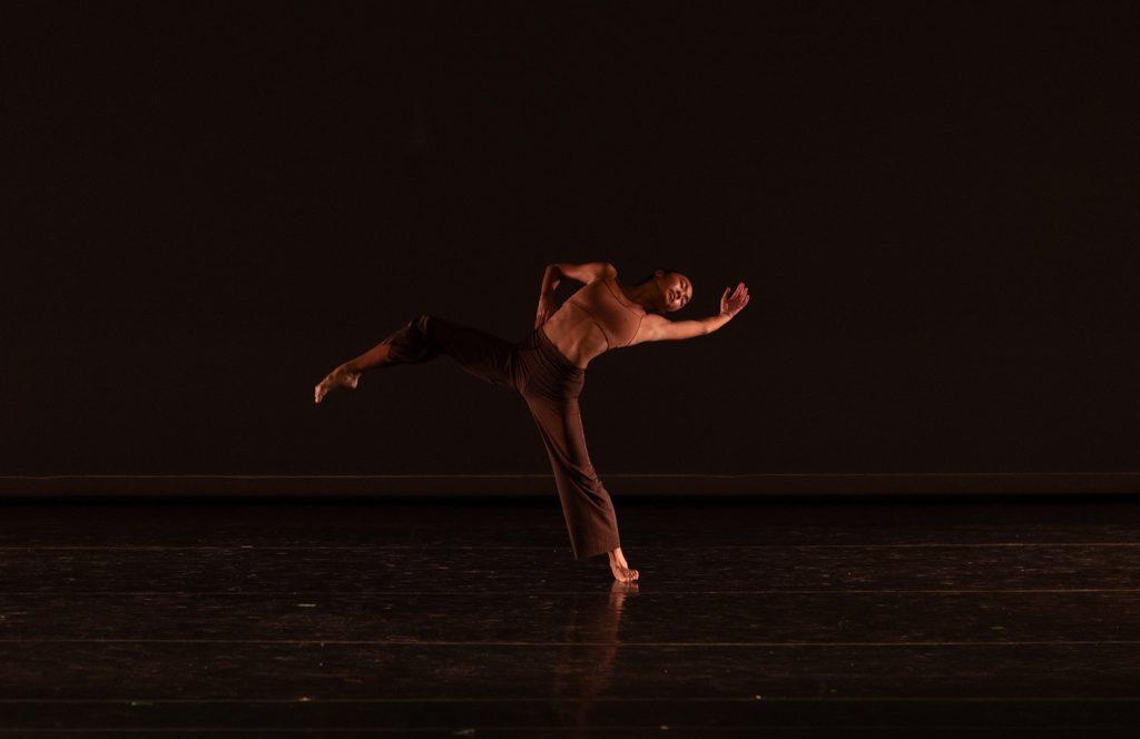 Kayla Mak demonstrates her flexibility and balance skills in her solo, "Human," on March 13. Circular, fluid motions blended with moments of sharp, precise gestures were present throughout the piece. Photo courtesy of Rosalie O’Connor