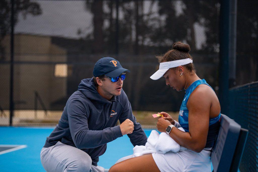 Interim Head Coach Tassilo Schmid speaks with senior Savannah Broadus during a match at the Ralphs-Straus Tennis Center on May 10, against University of Southern California. Schmid was named interim head coach after previous Head Coach Per Nilsson's leaving. Photos courtesy of Tassilo Schmid