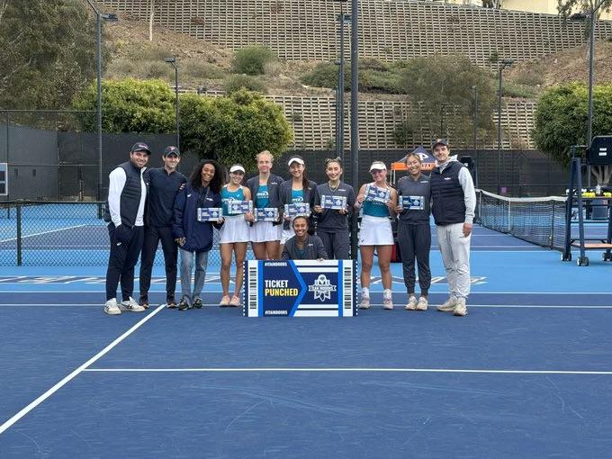 Schmid with the women's team after punching their ticket to the Indoor ITA National Championships on Jan. 25, at the Ralphs-Straus Tennis Center. Schmid and the Waves won 4-1 against the University of Arizona.