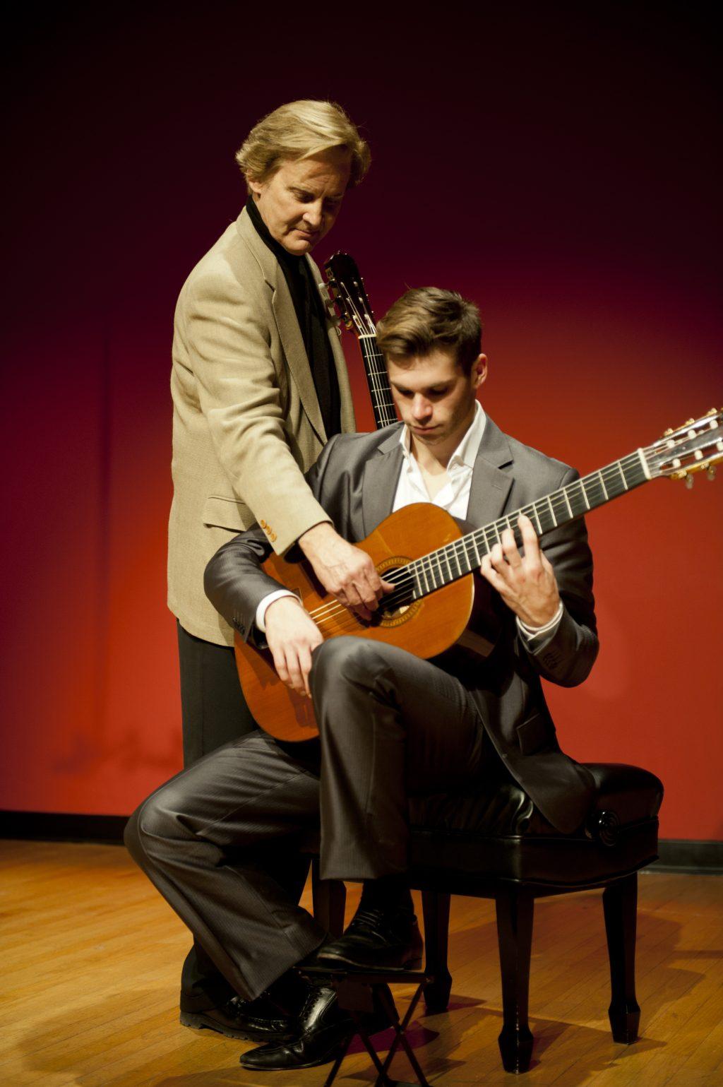 Parkening (left) instructs Music Adjunct Professor Kevin Enstrom. Enstrom helped organize the Feb. 22 Parkening Master Class.